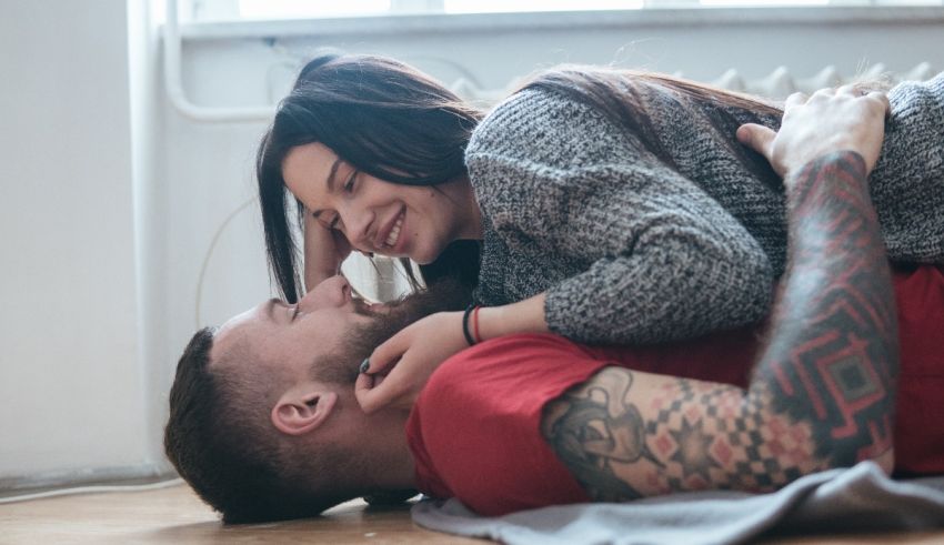 A man and woman laying on the floor together.