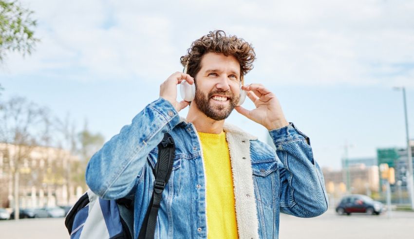 A young man with a backpack is talking on the phone.