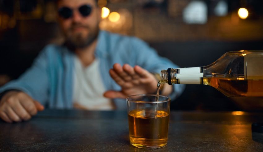 A man pouring whiskey into a glass.