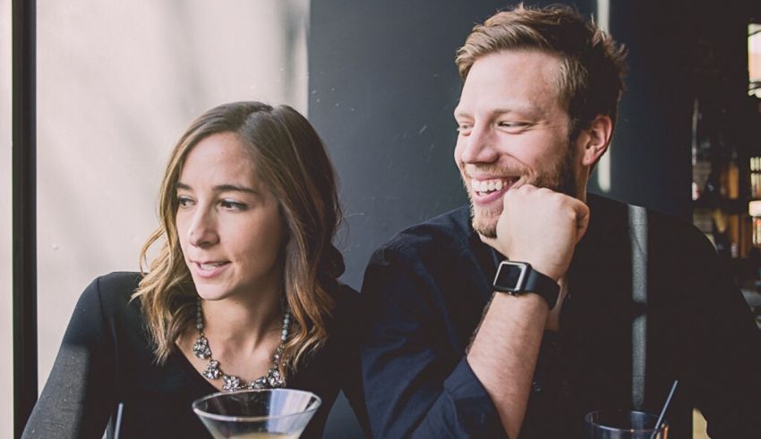 A man and woman sitting at a table.