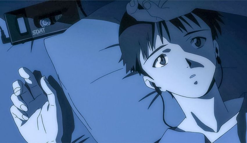 A man is laying in bed with his head in his hands.