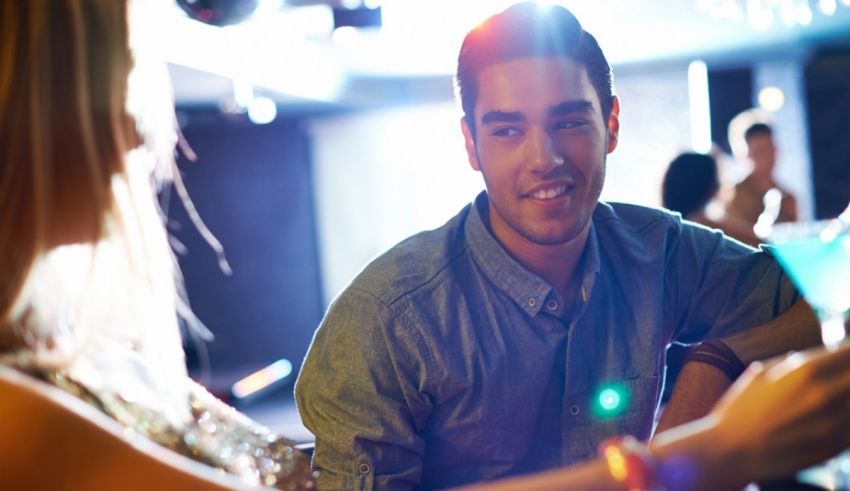 A man and woman enjoying a drink at a bar.