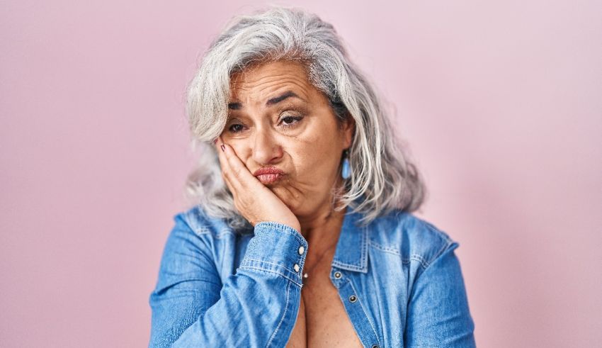 An older woman with grey hair and a smile on her face.