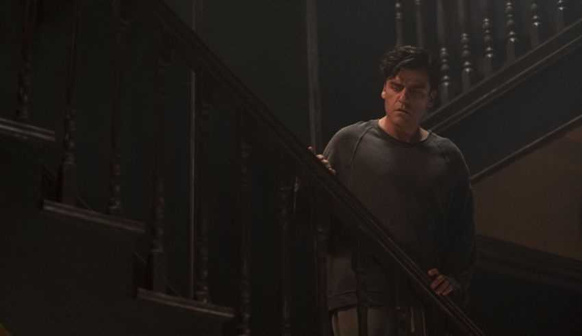 A man standing on a staircase in a dark room.