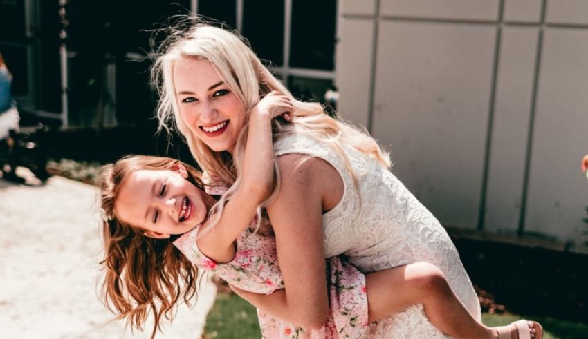 A woman is holding a little girl in her arms.