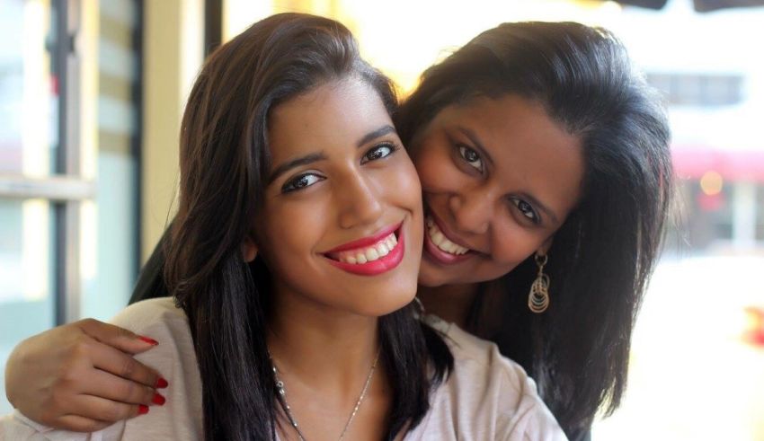 Two women posing for a photo in a restaurant.