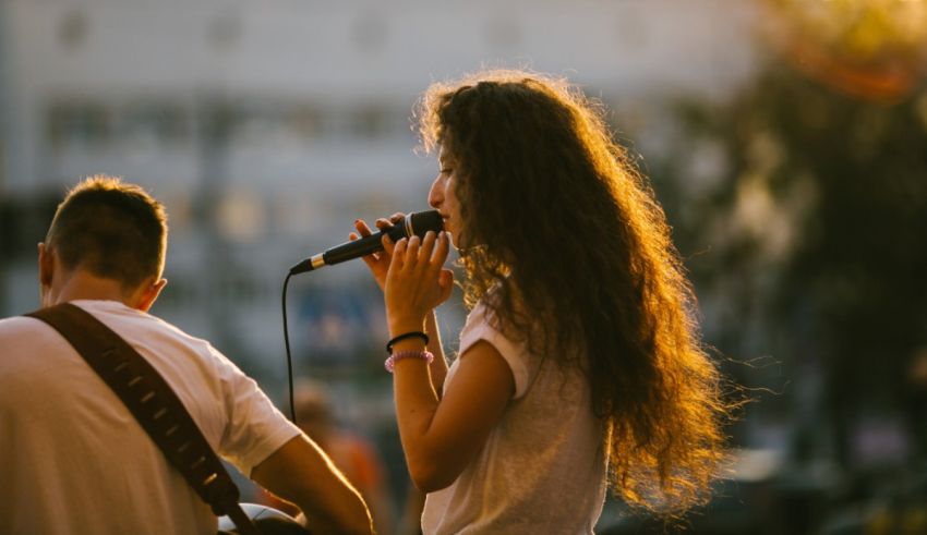 Two people singing in front of a microphone.