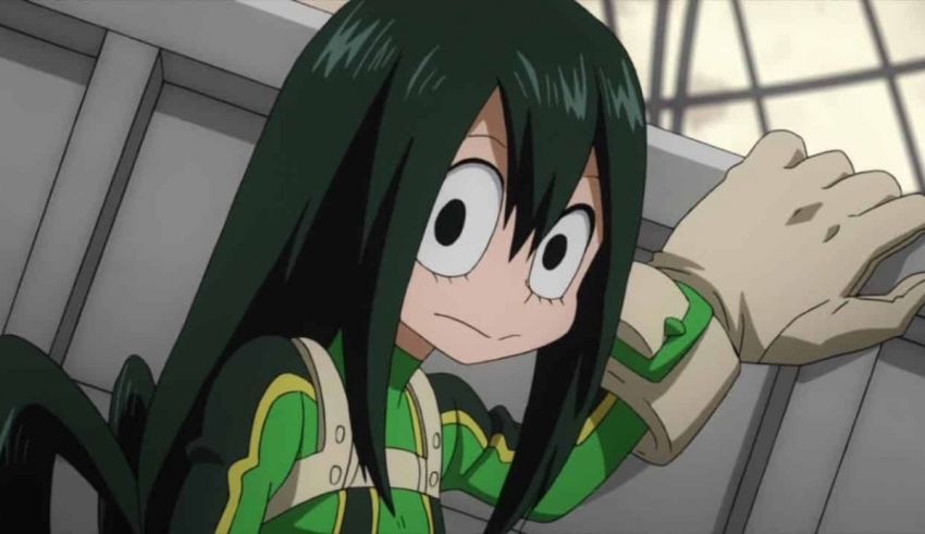 A girl with long black hair is standing on a railing.