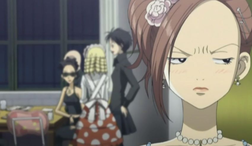 A woman is standing in front of a group of people.