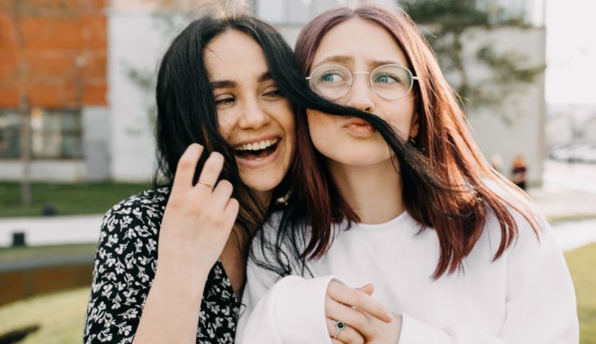 Two women hugging each other in a park.