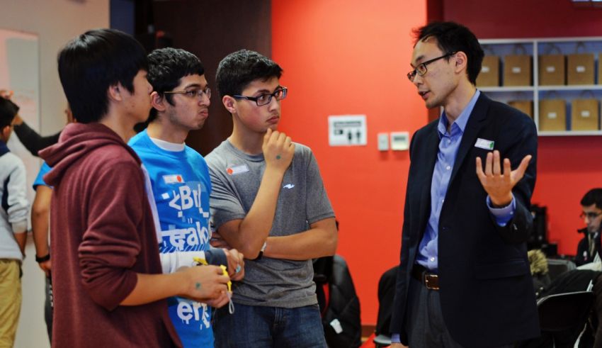 A group of people talking to each other in a room.