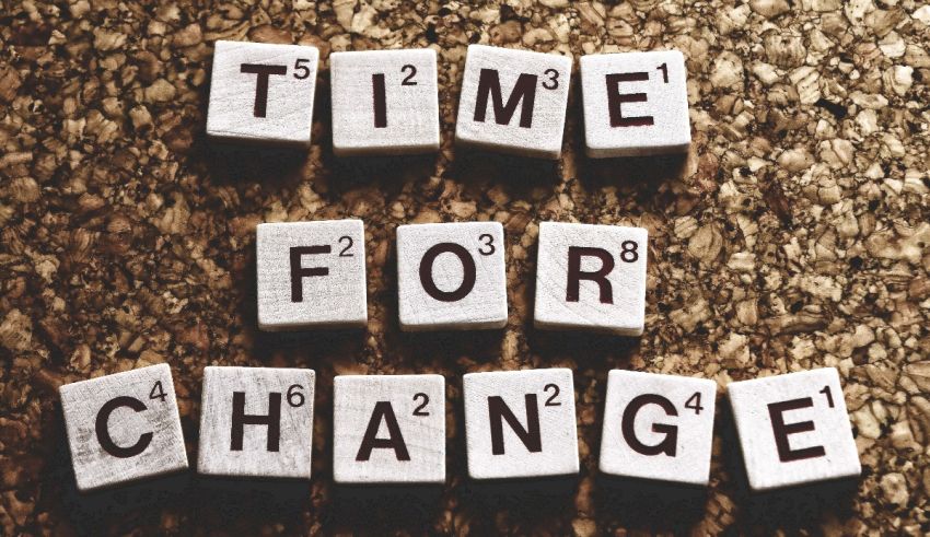 Time for change spelled out in wooden tiles.