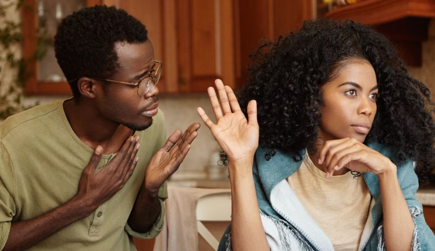 A man and woman in a kitchen talking to each other.
