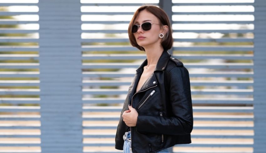 A woman wearing a black leather jacket and jeans.