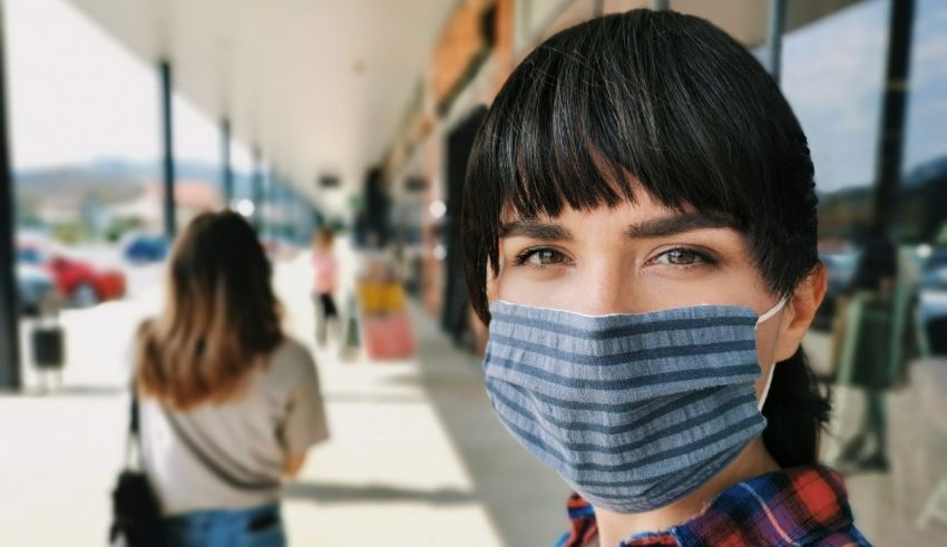 A woman wearing a face mask in a shopping mall.