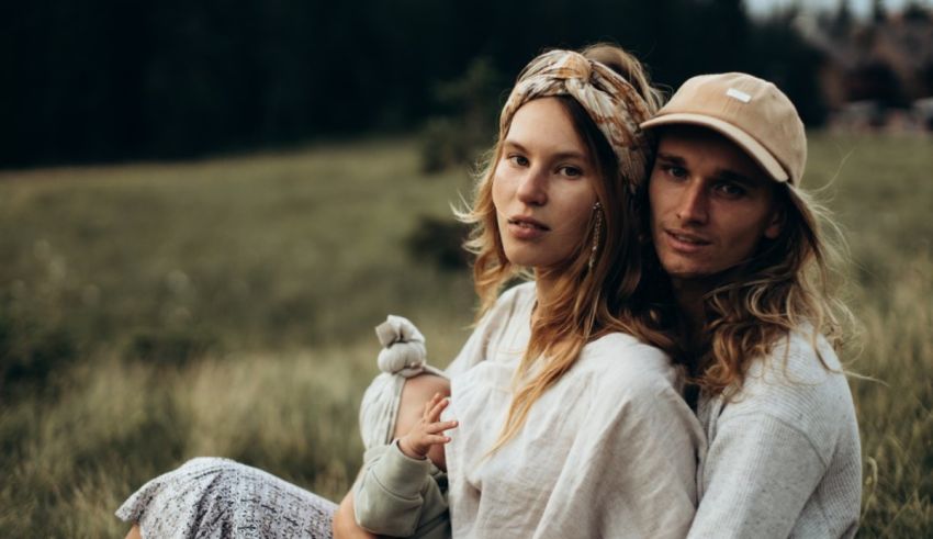 A man and woman sitting in grass.