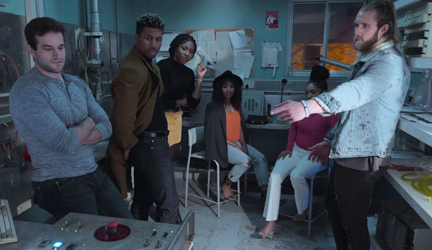 A group of people standing around in a lab.