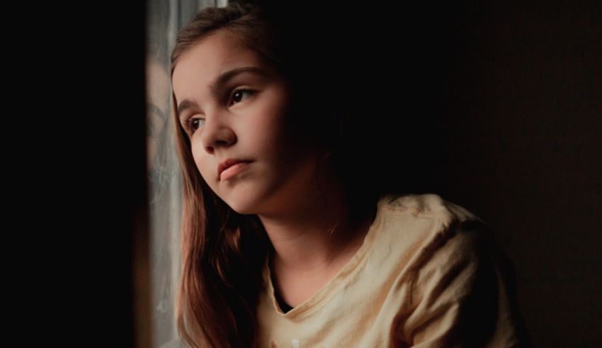 A young girl looking out a window.