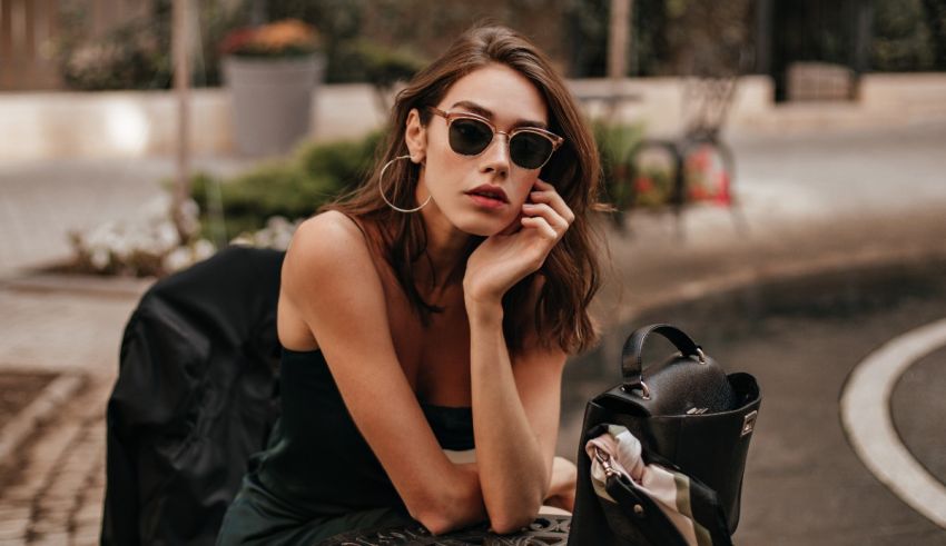 A woman wearing sunglasses sitting on a bench.