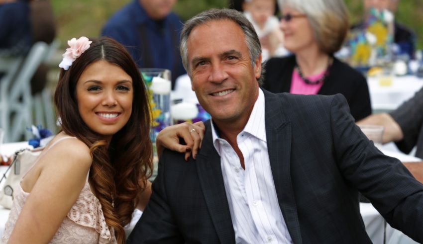 A man and woman posing for a photo at a wedding.