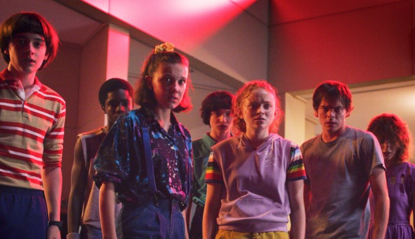 A group of young people standing in a hallway.