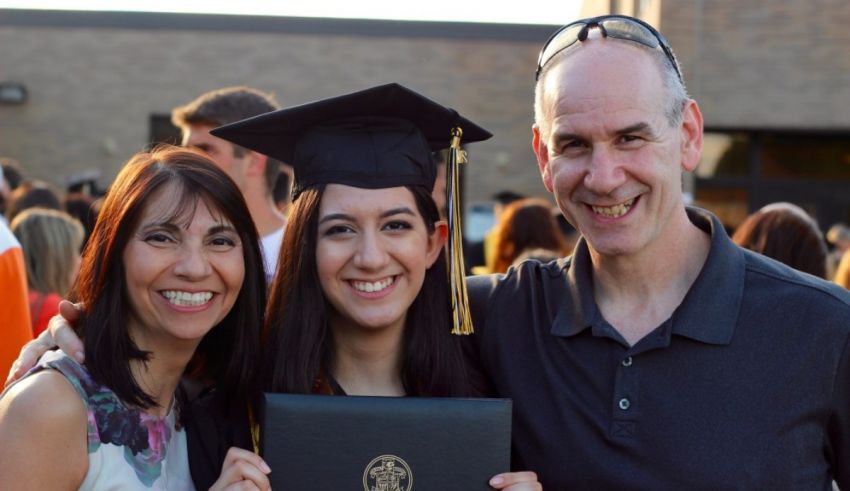 A man and woman are posing for a photo with their diplomas.