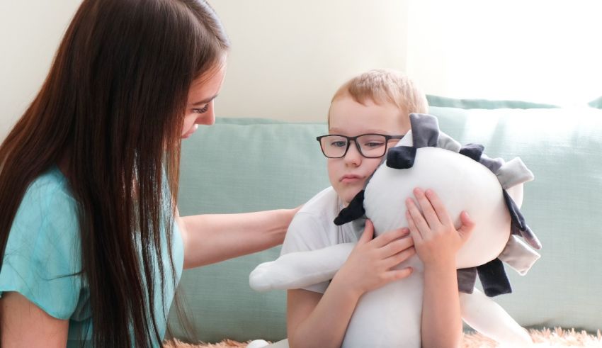 A woman with glasses is holding a stuffed animal.