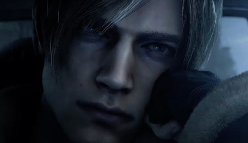 A man is sitting in a car looking at his phone.