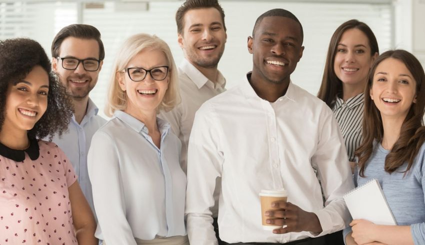A group of smiling business people in an office.