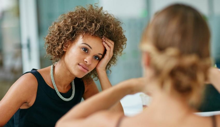 Two women sitting at a table talking to each other.