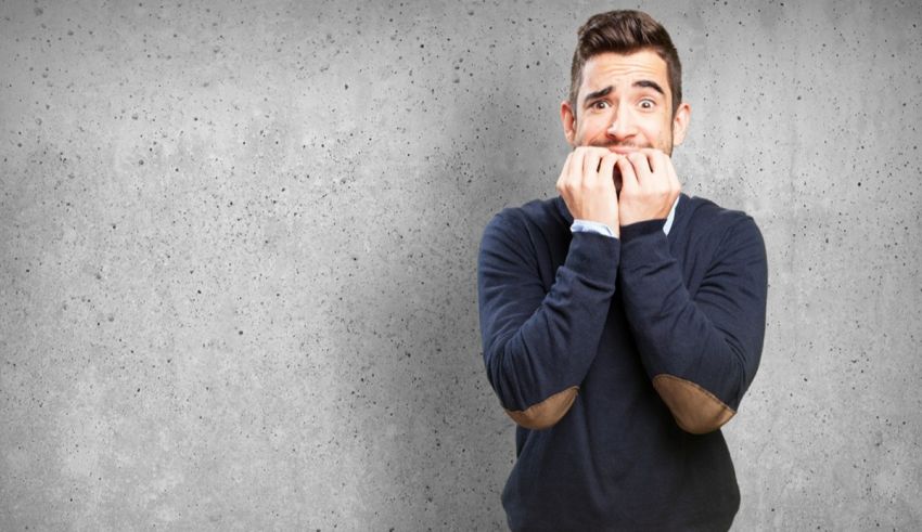 A man covering his mouth with his hands.
