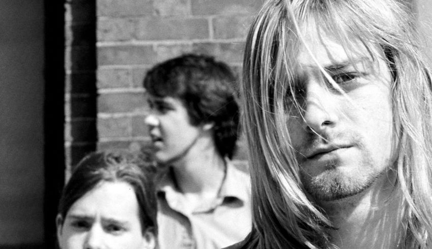 A black and white photo of a group of people with long hair.