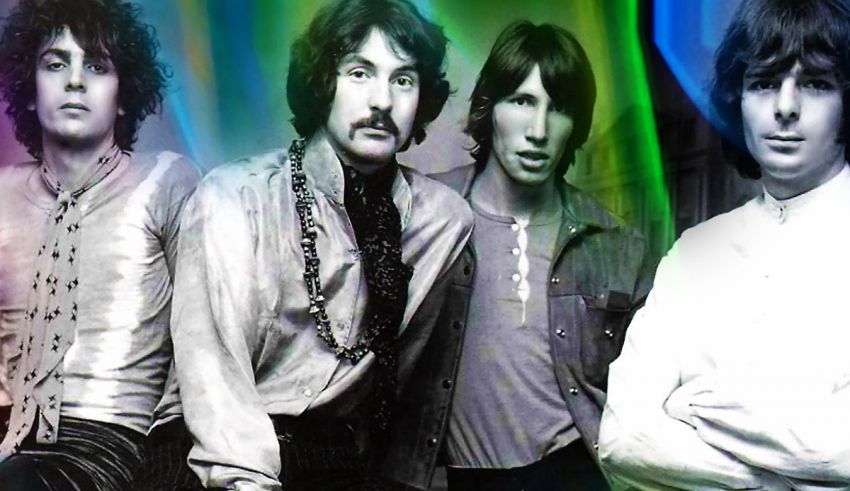 A group of people standing in front of a colorful background.