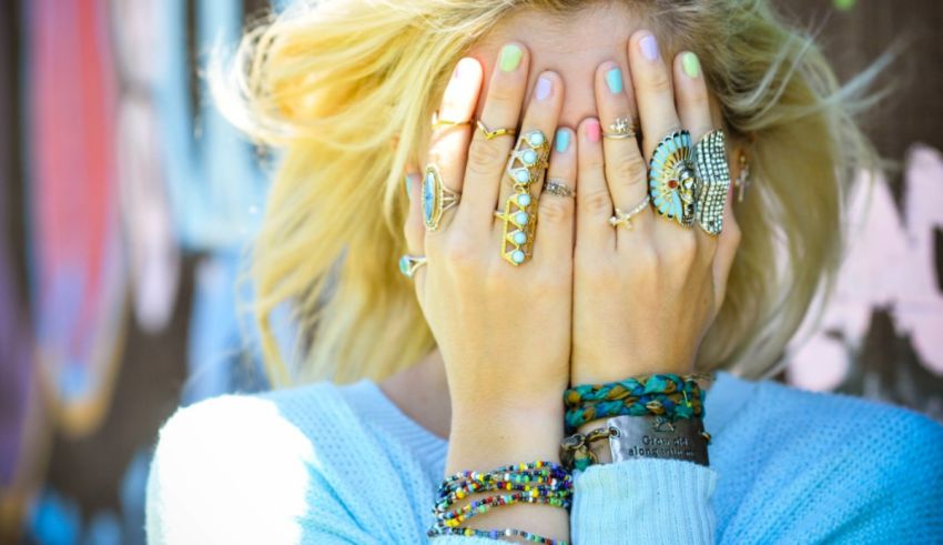 A woman is covering her face with her hands.