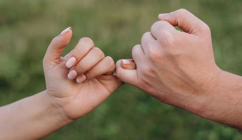 A man and a woman holding hands in a field.