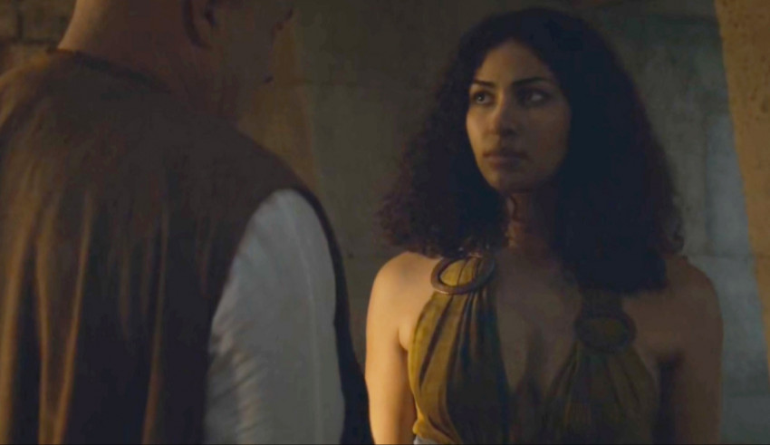 A woman in a brown dress is standing next to a man.