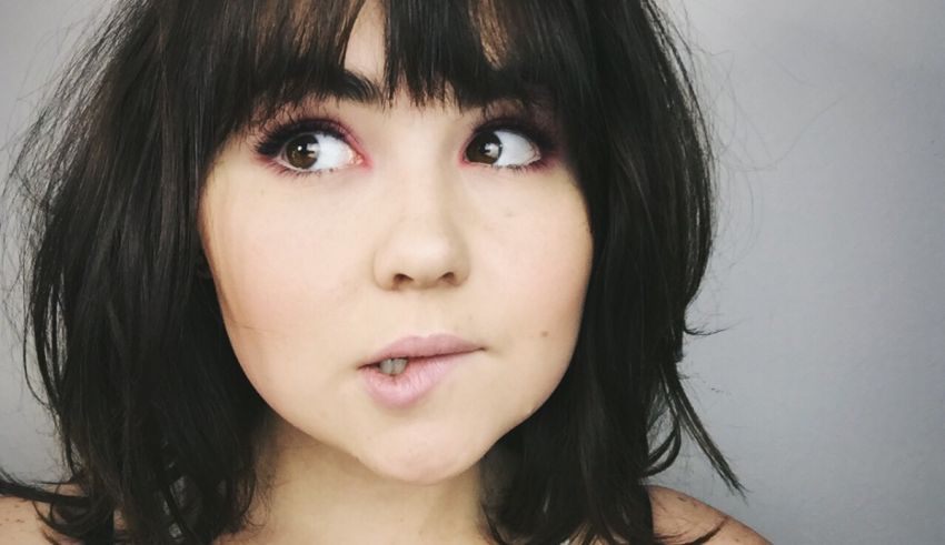 A woman with brown hair and bangs.