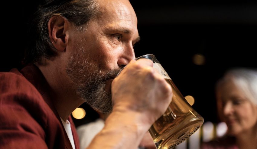 A man is drinking a beer in a bar.