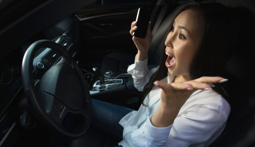 A woman in a car talking on her cell phone.