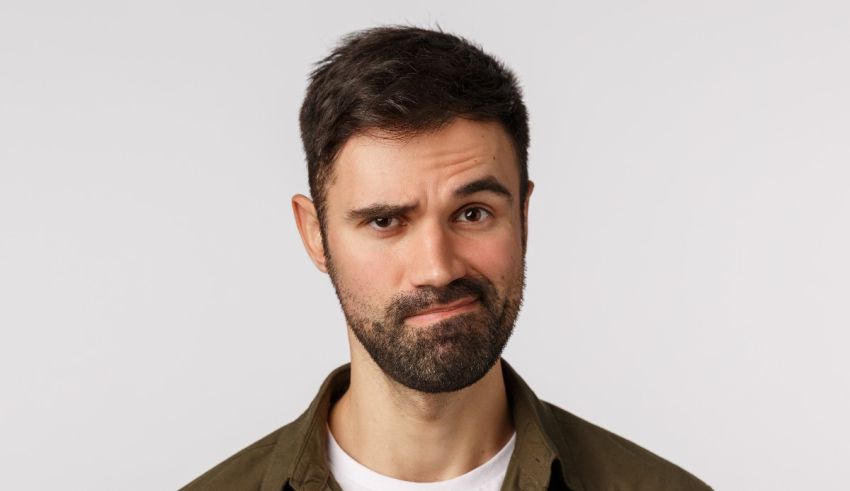 A man with a beard is looking at the camera.