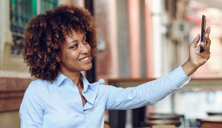 A woman is taking a selfie with her cell phone.