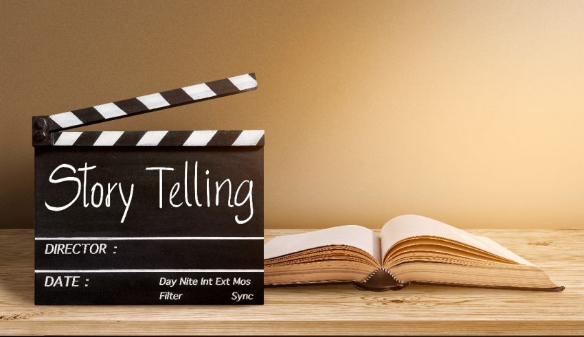 A movie clapper next to a book on a wooden table.
