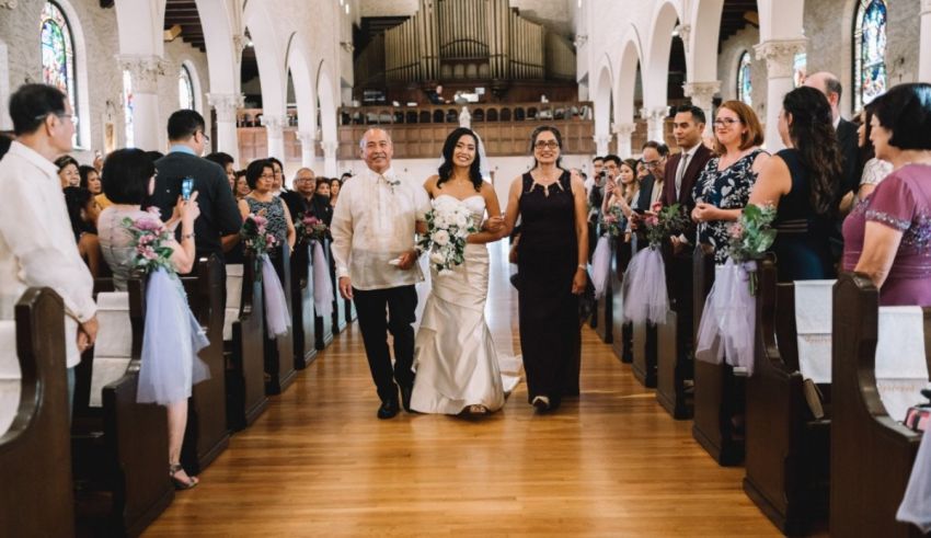 A bride and groom walking down the aisle of a church.