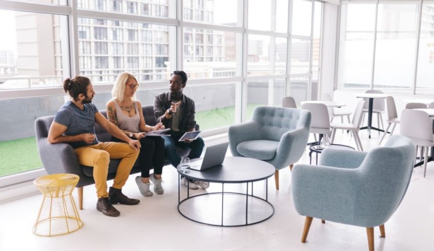 Four people sitting in a conference room.