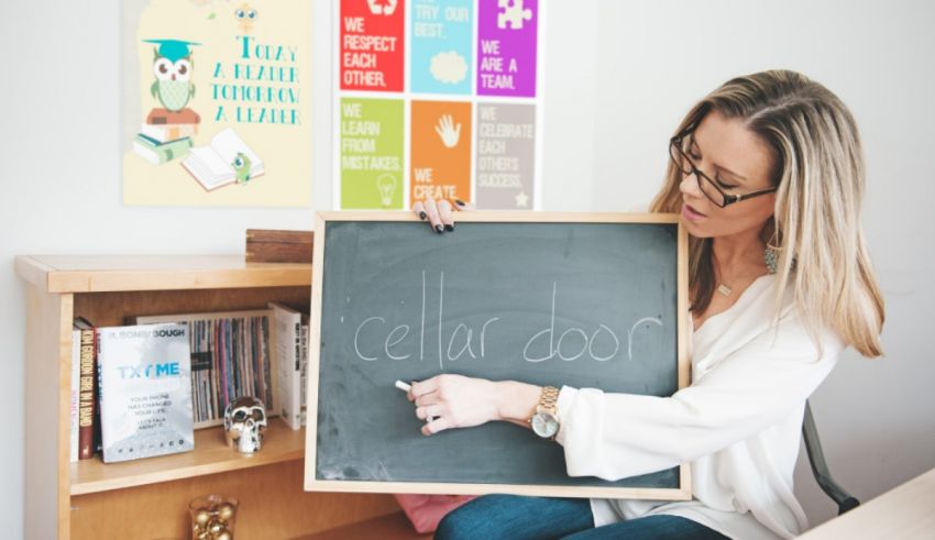 A woman writing on a chalkboard.