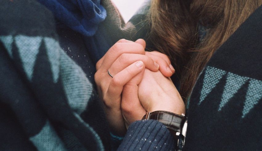 Two people holding each other's hands.