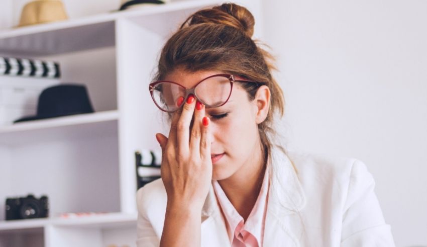 A woman is holding her head in her hands.