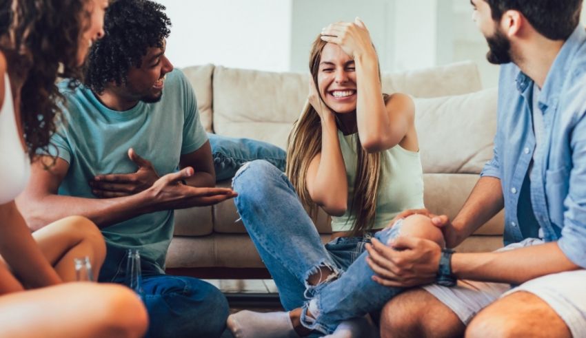 A group of people sitting on the floor in a living room.