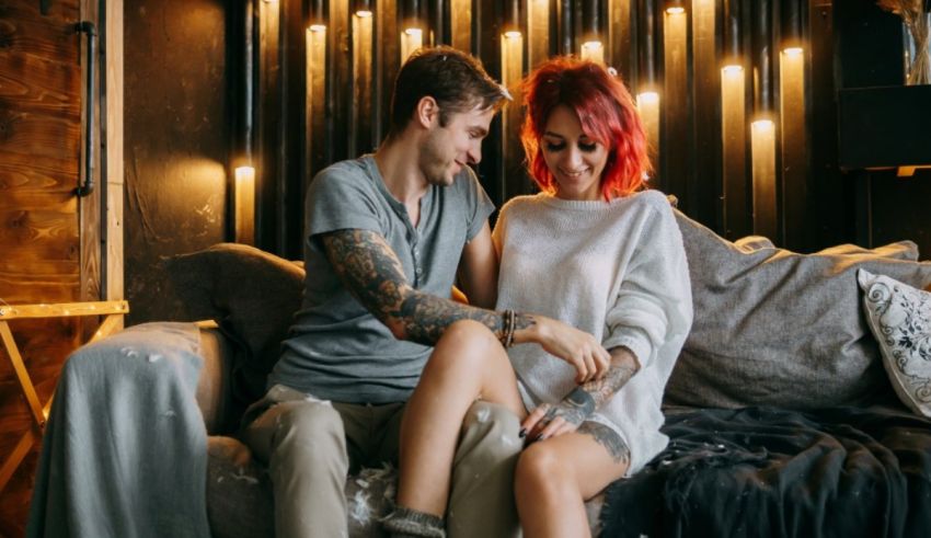 A man and woman sitting on a couch.