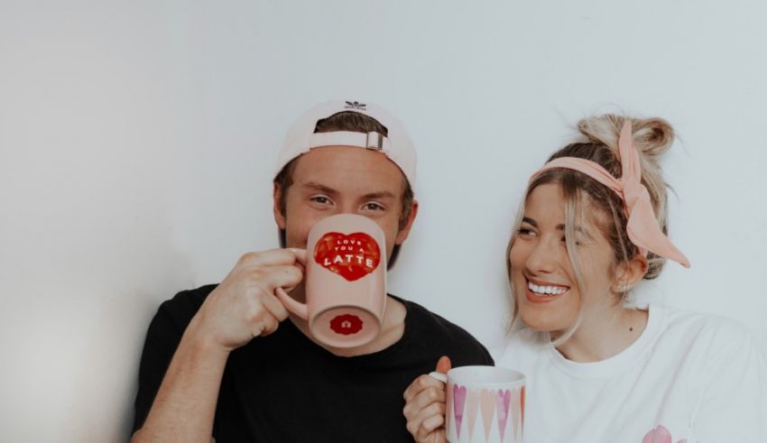 A man and woman holding coffee mugs.